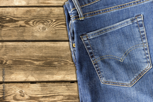 Close up of jeans pants on wooden background