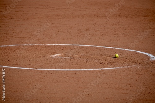 Softball left in the circle for the next pitcher. photo