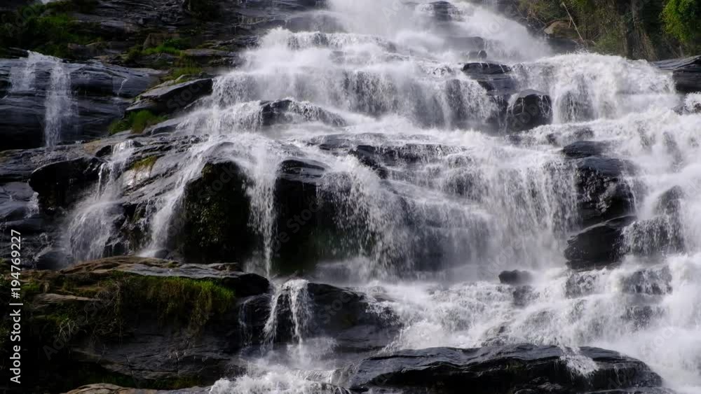 Close up.Pure fresh water waterfall in forest with black rocks. Close up.Pure fresh water waterfall in forest with black rocks.