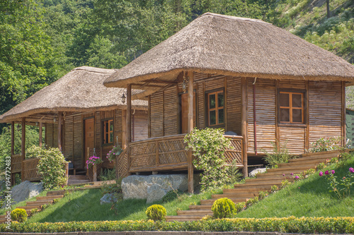 wooden vacation bungalows in jungle photo