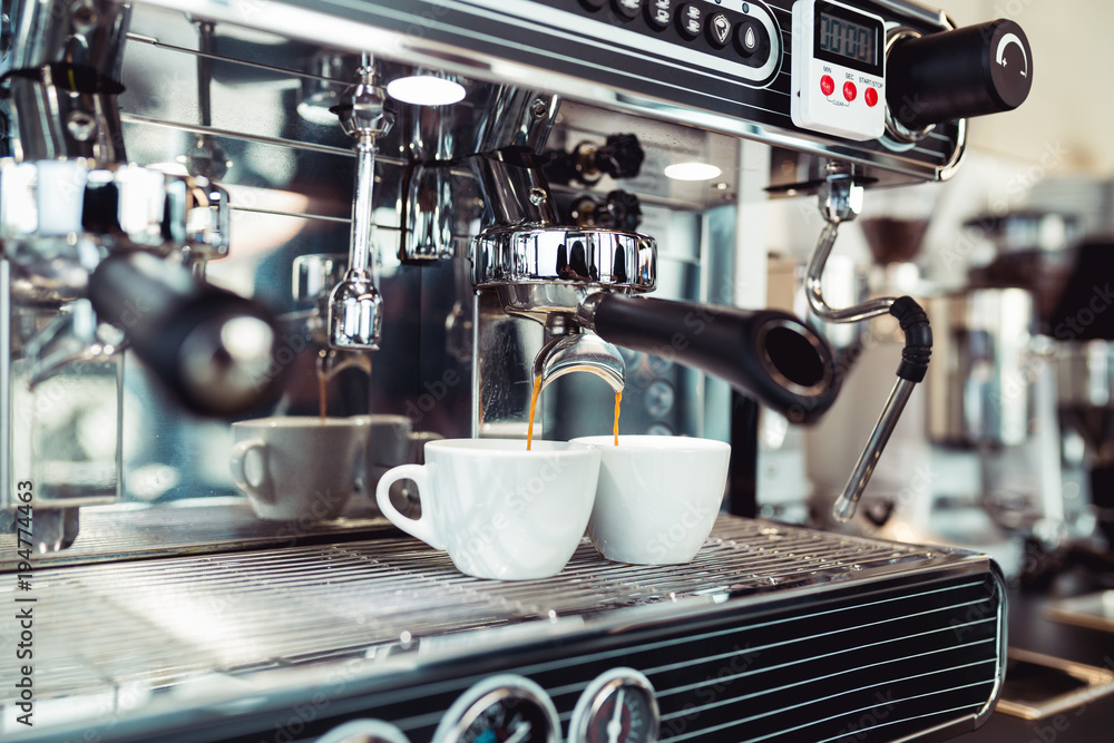 Aluminium schilderij met Espresso pouring from coffee machine into coffee cup. #194774463