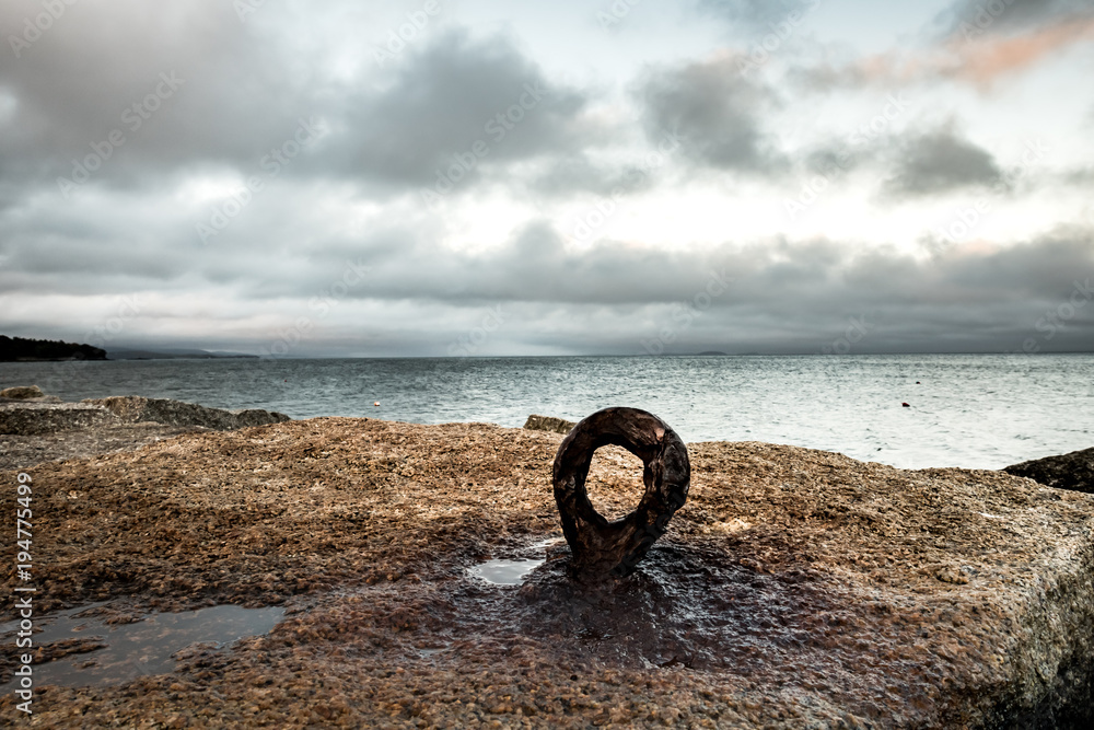 Fototapeta premium Rusty Eyebolt in the Rocks of Rockland Breakwater