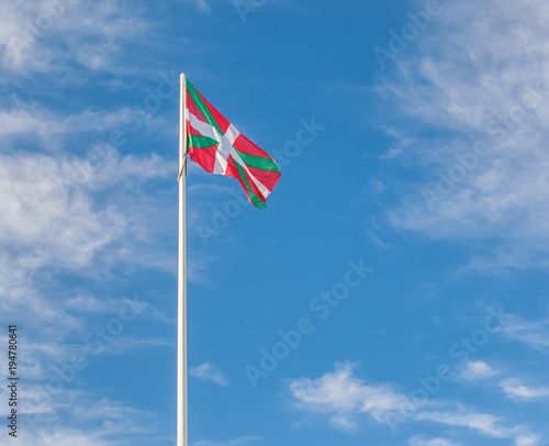 Basque flag waving in the wind against the sky