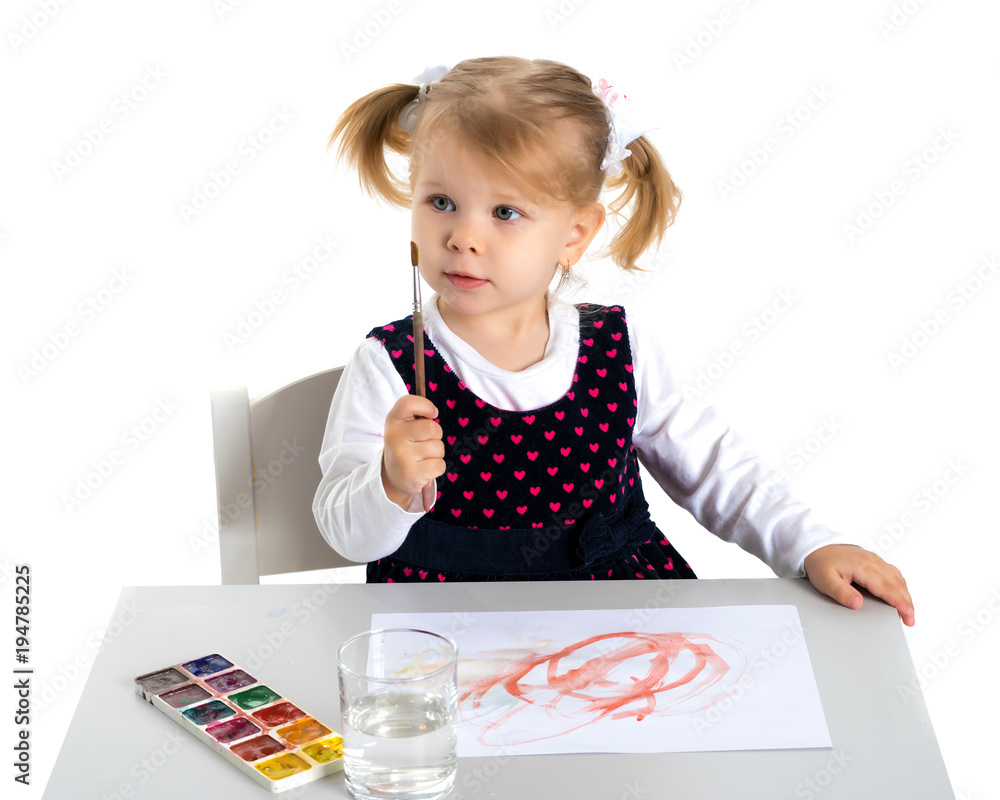 A little girl is drawing at the table. A little girl is drawing at the table.