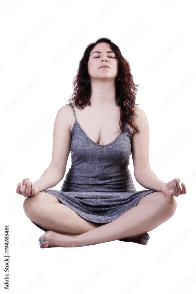 Young Caucasian Woman Sitting In Lotus Position With Gray Dress Young Caucasian Woman Sitting In Lotus Position With Gray Dress