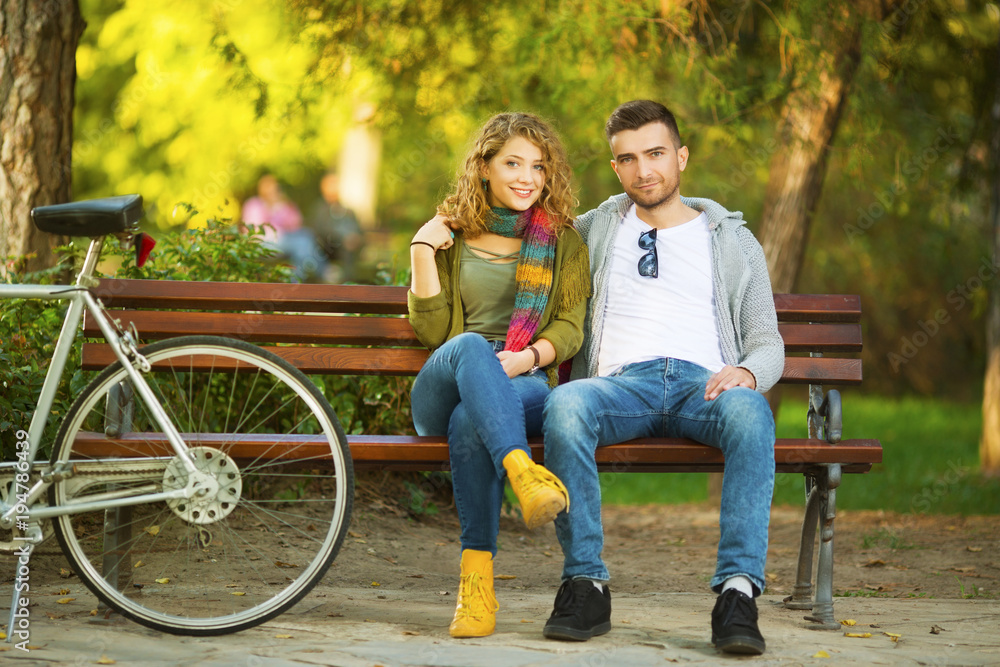 Young couple in park with bicycle Young couple in park with bicycle