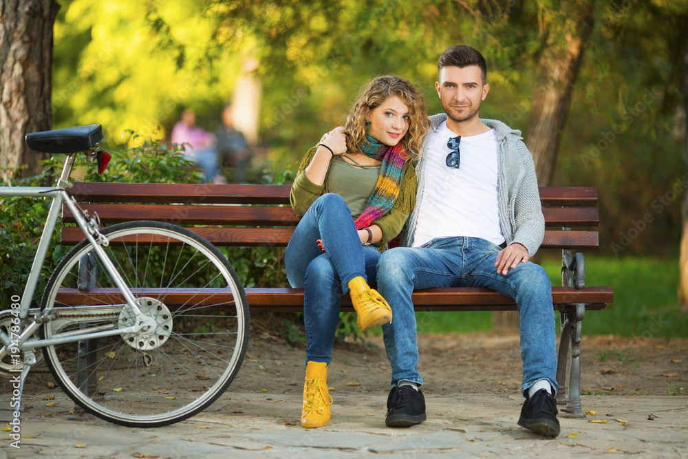 Young couple in park on a bench Young couple in park on a bench