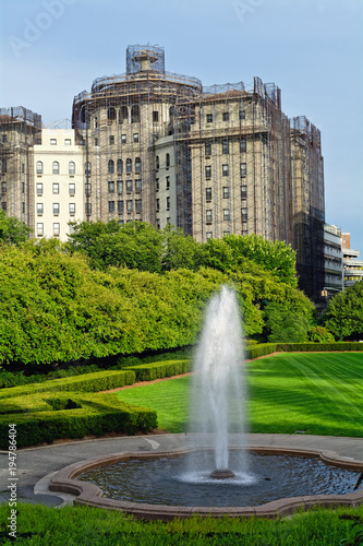 Conservatory Garden Center Fountain in Central Park, with Fifth Avenue buildings in the background, New York City, USA.