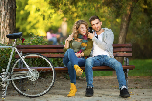 Young couple in park on a bench