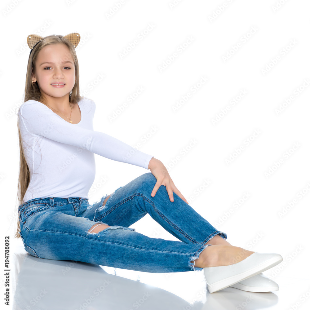 Beautiful teen girl in jeans with holes. Photos | Adobe Stock