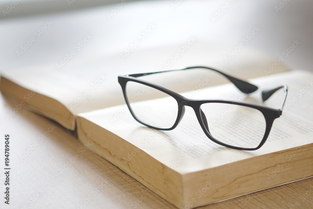 Glasses and books placed on table in the livingroom . Glasses and books placed on table in the livingroom .