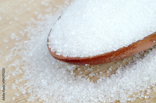 White sugar on wooden spoon.Food and health concepts