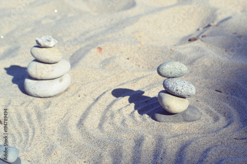Balanced rocks in zen garden sand circles