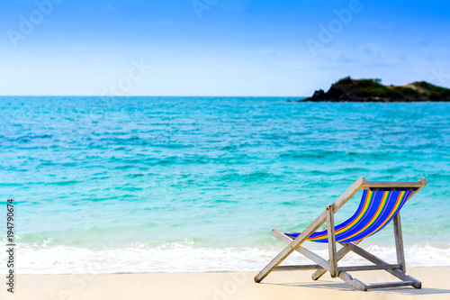 A seat on the beach with blue sea background
