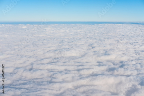 White clouds with blue sky and horizon in beautiful day  above view from air plane