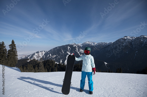 one snowboarder with snowboard on winter mountain top