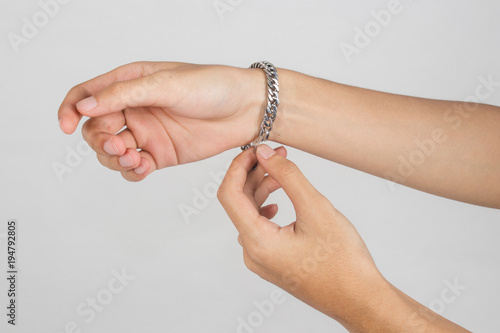 Wearing a bracelet on arm isolated on white background.