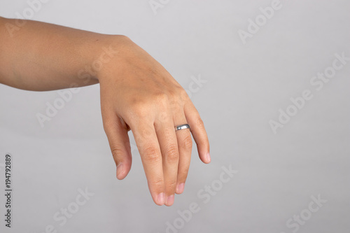 Close-up a ring on ring finger to show honesty of love isolated on white background.