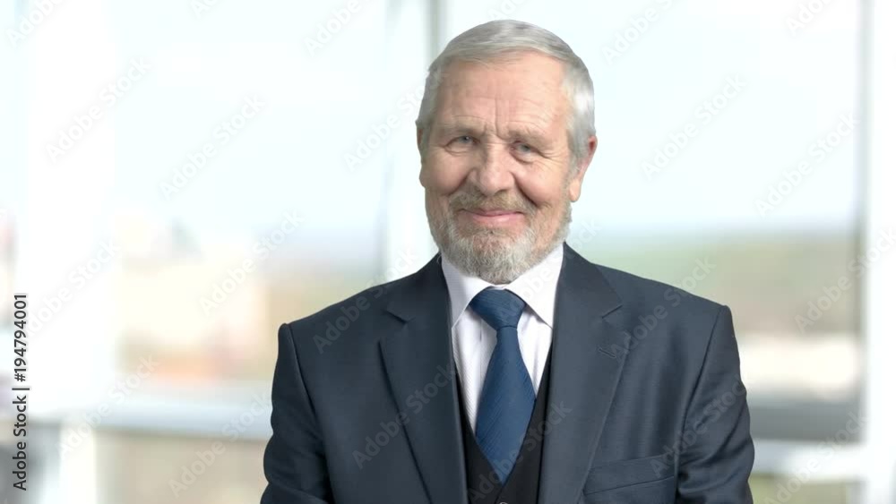 Flirting elderly businessman, blurred background. Senior man in business suit flirting wit eyes. Invitation for a date. Flirting elderly businessman, blurred background. Senior man in business suit flirting wit eyes. Invitation for a date.