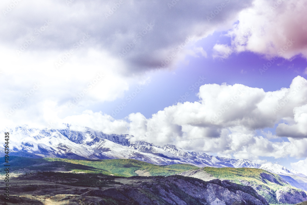 Colorful view of the mountain snow peaks under the clouds. Colorful view of the mountain snow peaks under the clouds.
