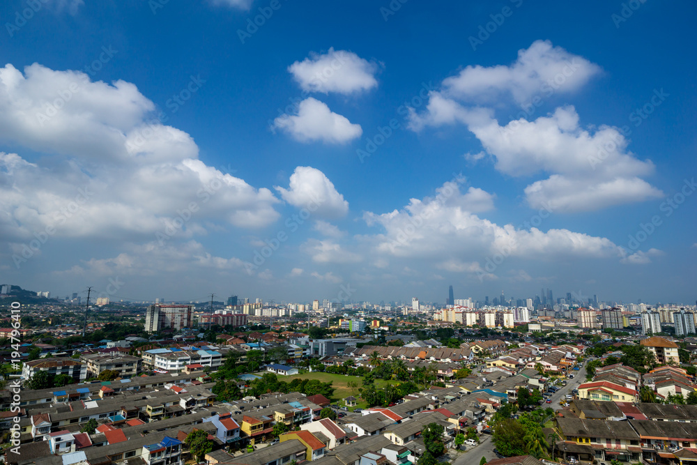 A clear and windy day in Kuala Lumpur, capital of Malaysia. Its modern skyline is dominated by the 451m tall KLCC, a pair of glass and steel clad skyscrapers.