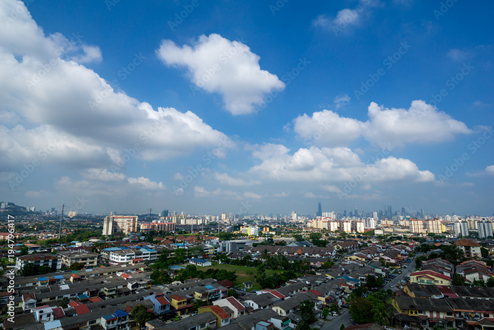 A clear and windy day in Kuala Lumpur, capital of Malaysia. Its modern skyline is dominated by the 451m tall KLCC, a pair of glass and steel clad skyscrapers.