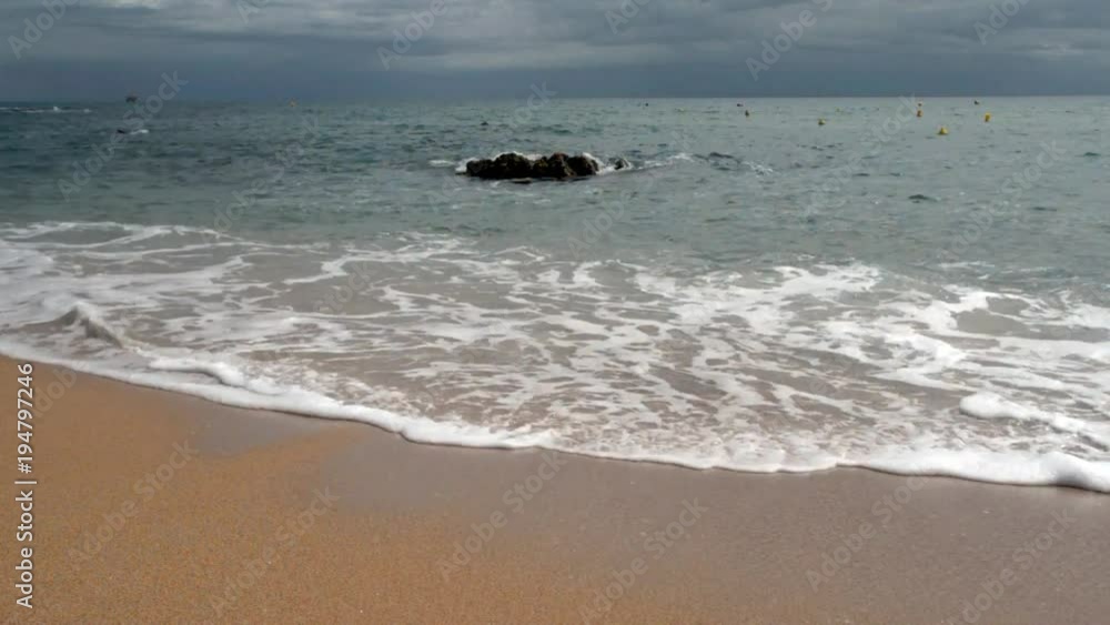 Sea surf on the beach of Santa Cristina in Lloret de Mar Sea surf on the beach of Santa Cristina in Lloret de Mar
