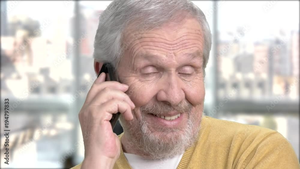 Elderly guy talking on mobile phone. Close up senior man talking on his telephone and looking happy, blurred background. Elderly guy talking on mobile phone. Close up senior man talking on his telephone and looking happy, blurred background.