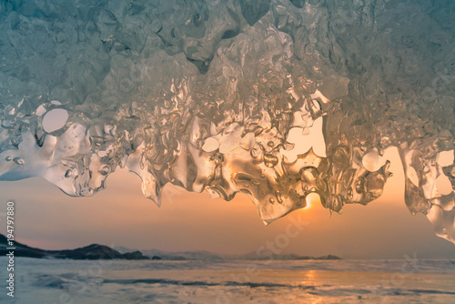 Beautiful Ice caved with sunset sky winter season natural landscape background, Siberia Russia photo