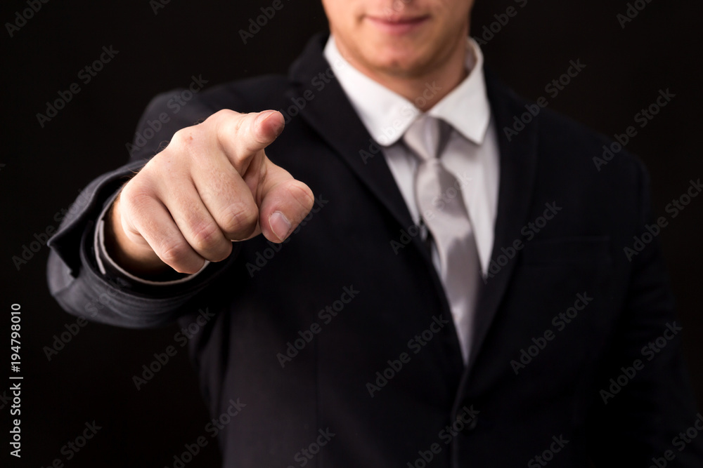Businessman pressing on virtual screens isolated on black background Businessman pressing on virtual screens isolated on black background