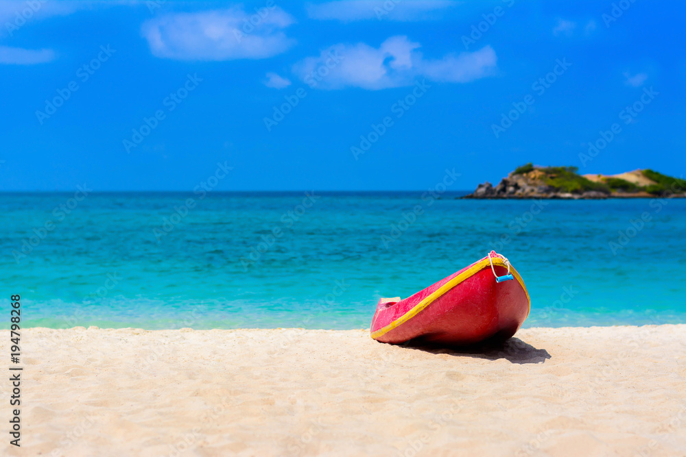 Red boat on the beach with blue sea and blue sky background Red boat on the beach with blue sea and blue sky background