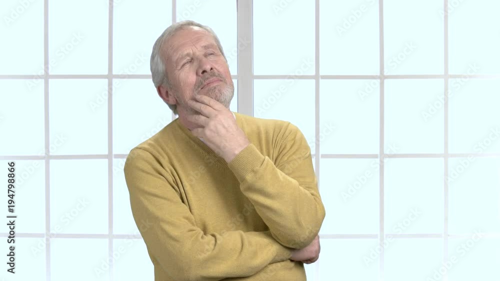Elderly male person is thinking. Senior man trying to remember something in deep thoughts. Pensive grandfather trying to recollect something in memory. Elderly male person is thinking. Senior man trying to remember something in deep thoughts. Pensive grandfather trying to recollect something in memory.