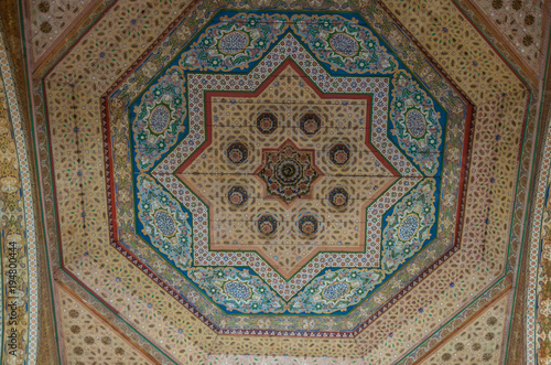 Ornate handcarved wooden ceiling insert at the ancient Bahia Palace in Marrakech, Morocco