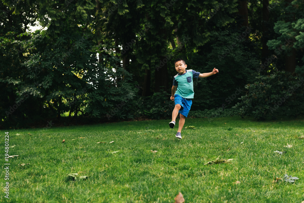 Little boy playing in a park Little boy playing in a park