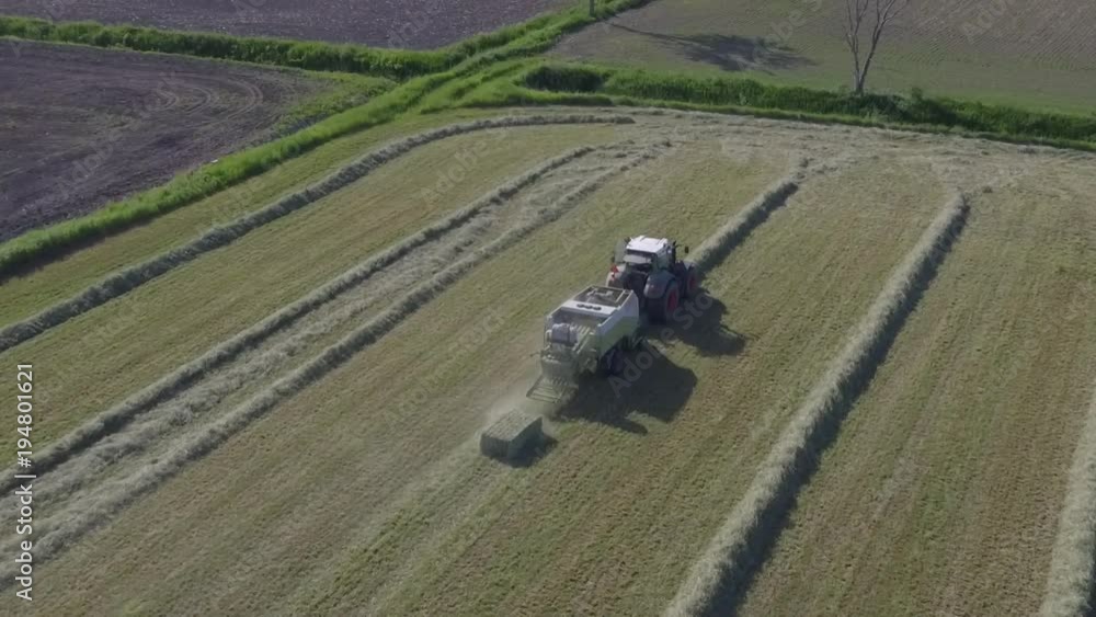aerial tractor drops big bale of hay 120fps slow motion aerial tractor drops big bale of hay 120fps slow motion
