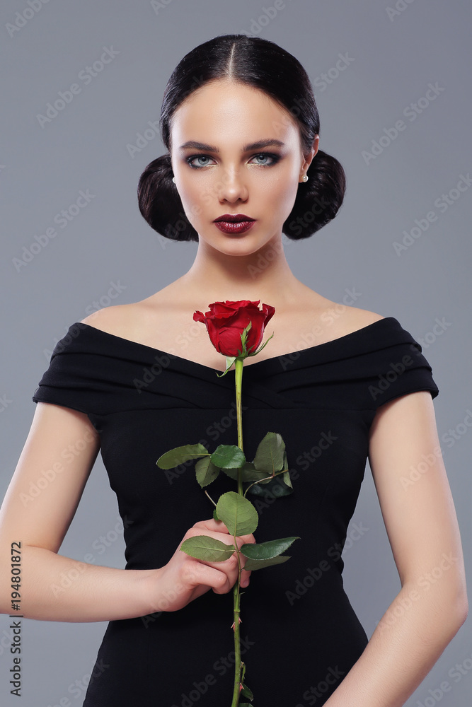 Young beautiful woman in black dress with red rose Young beautiful woman in black dress with red rose