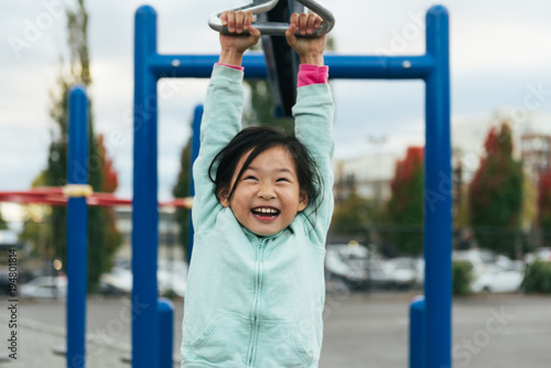 Girl zip lining at playground