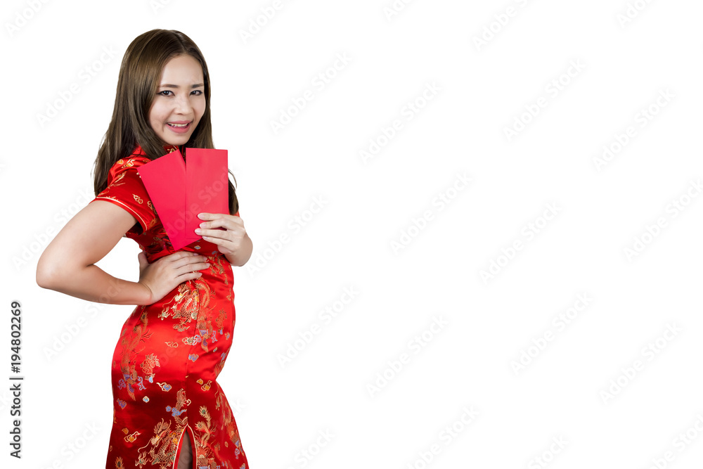 Beauty asian woman wearing cheongsam or qipao holding red envelopes and smiling in Happy Chinese New Year. Beauty asian woman wearing cheongsam or qipao holding red envelopes and smiling in Happy Chinese New Year.