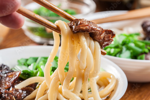 Japanese Udon noodles with beef, green onion and soup photo