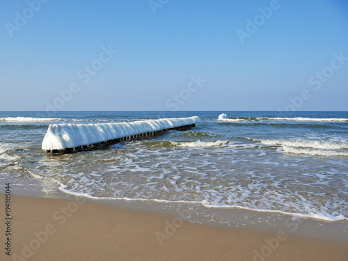 Polish sea in sunny winter with icicles