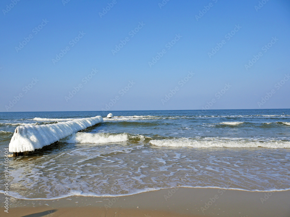 Polish Mielno sea in sunny winter with icicles - obrazy, fototapety, plakaty 