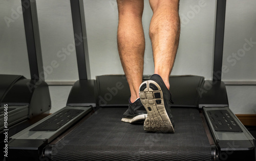 people running on a treadmill in gym for exercising