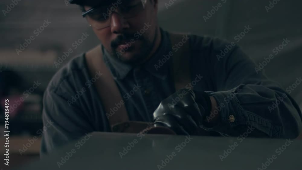 Worker using industrial grinder. Worker in garage makes work with metall and grinder. Slow motion how flying sparks Worker using industrial grinder. Worker in garage makes work with metall and grinder. Slow motion how flying sparks