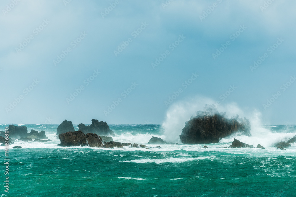 Wild waves crashing on rocks in the sea at Tsumekizaki Park near Shimoda, izu peninsula, Japan