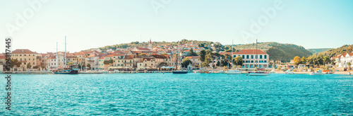 POSTIRA, CROATIA - JULY 14, 2017: Beautiful harbor of a small town Postira with several yachts moored there - Croatia, island Brac
