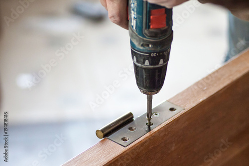 Manual manufacturing of furniture from a natural tree in a workshop.