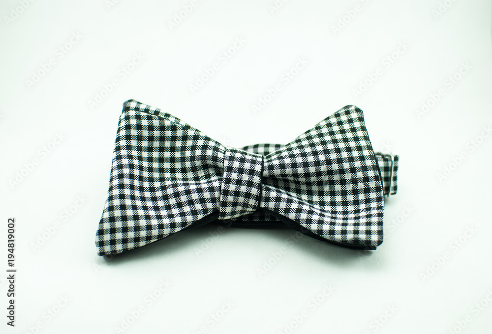 A stylish and well-designed white-black bow tie on a white background; isolated A stylish and well-designed white-black bow tie on a white background; isolated