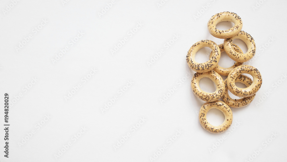 bagels with poppy seeds on white background, copy space bagels with poppy seeds on white background, copy space
