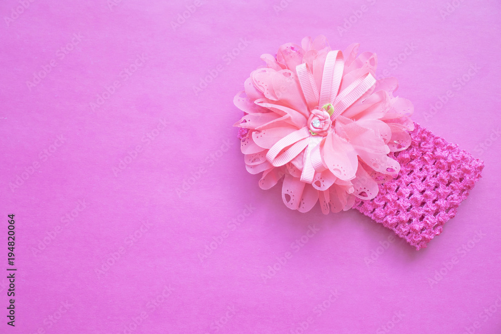 pink bezel with flower on pink background pink bezel with flower on pink background