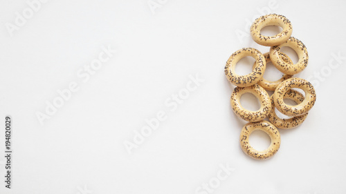 bagels with poppy seeds on white background, copy space